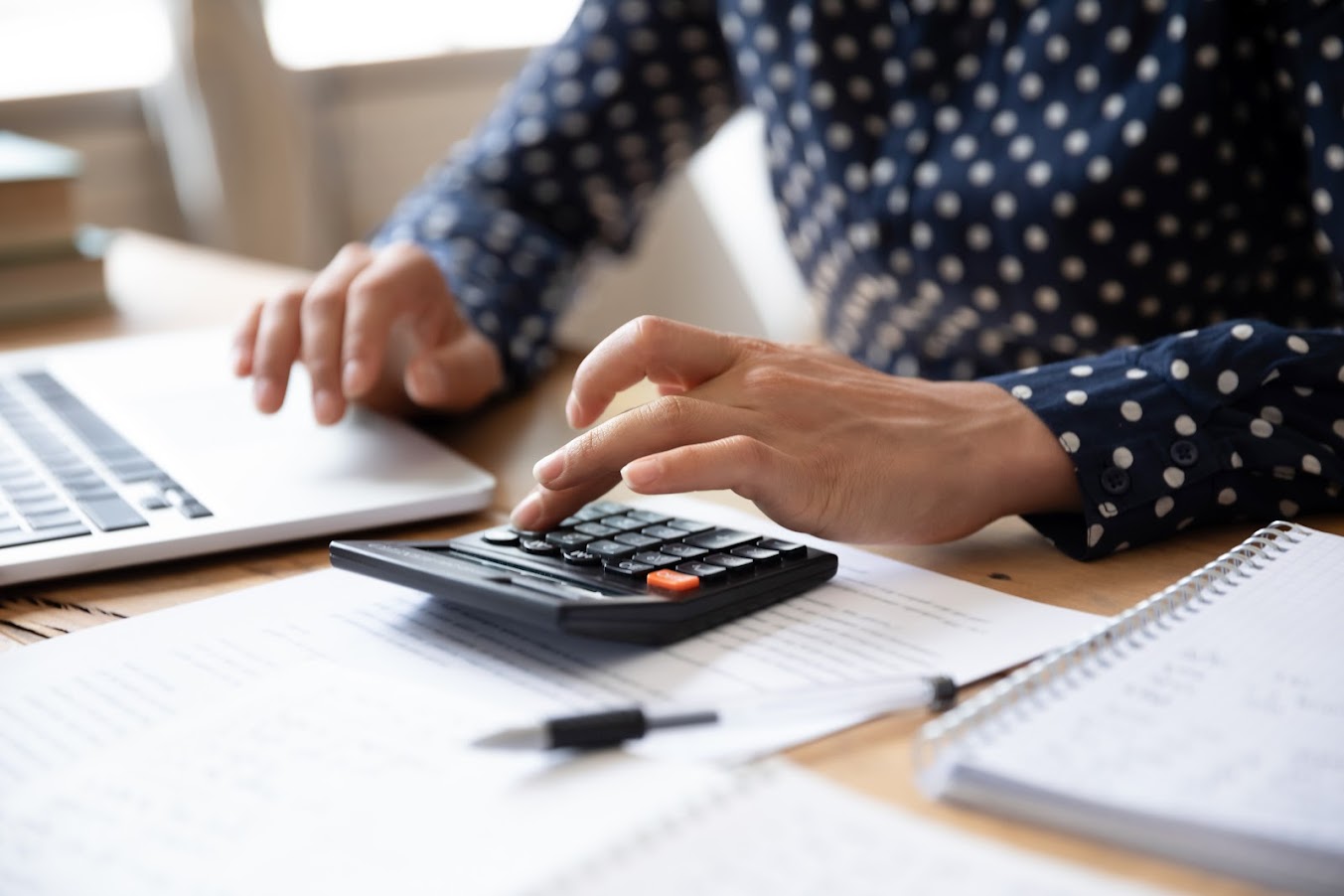 Young woman using calculator