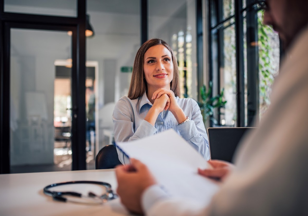 Interviewer and interviewee sitting in conversation at an office desk