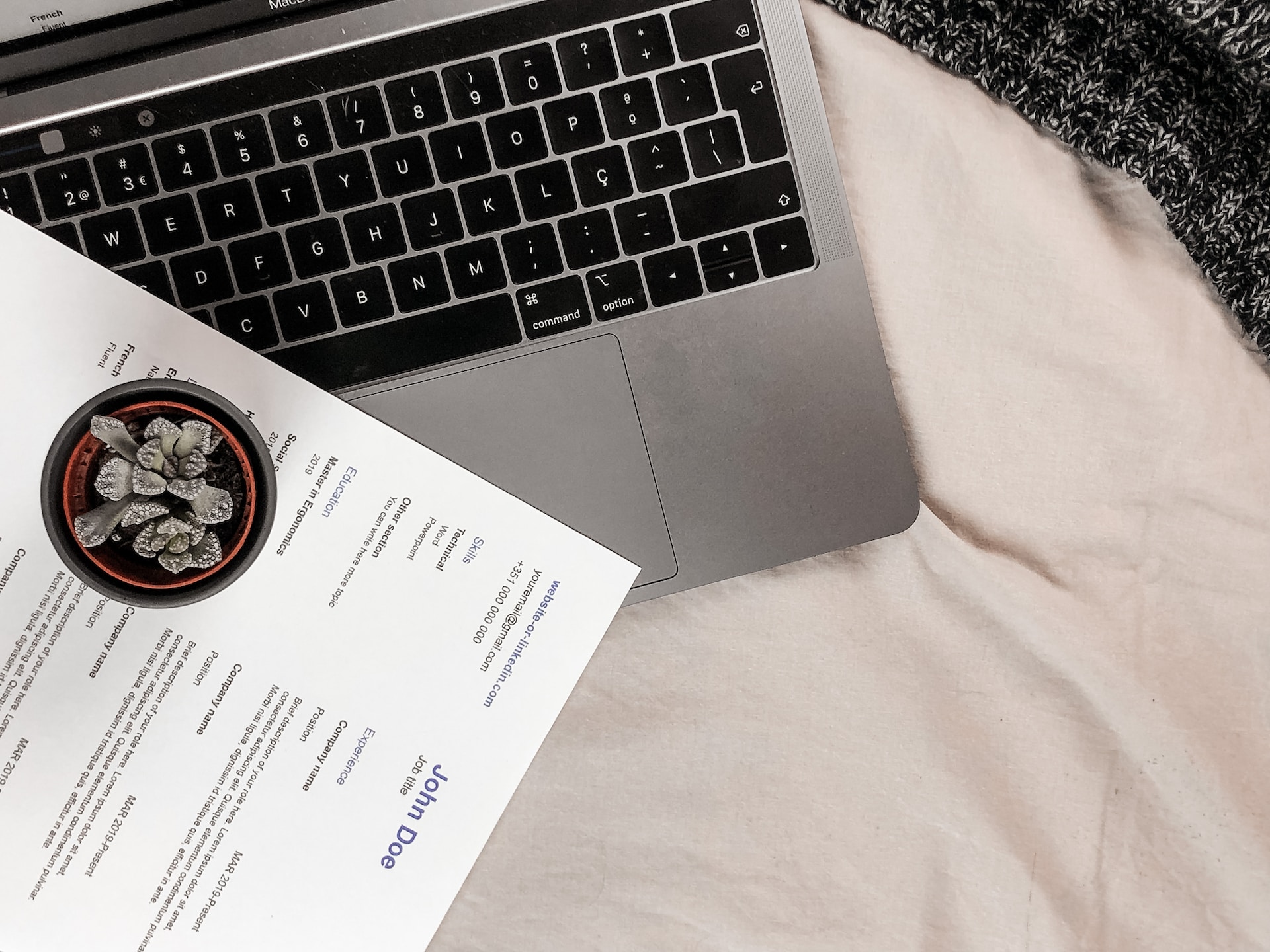 An example CV next to a laptop.